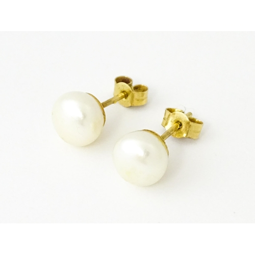 685 - A pair of 9ct gold stud earrings set with pearls.