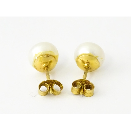 685 - A pair of 9ct gold stud earrings set with pearls.