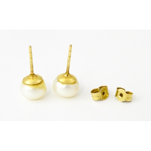 685 - A pair of 9ct gold stud earrings set with pearls.