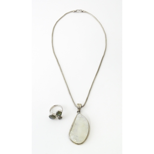 687 - A silver pendant set with labradorite hardstone. Together with a silver hardstone set with three lab... 