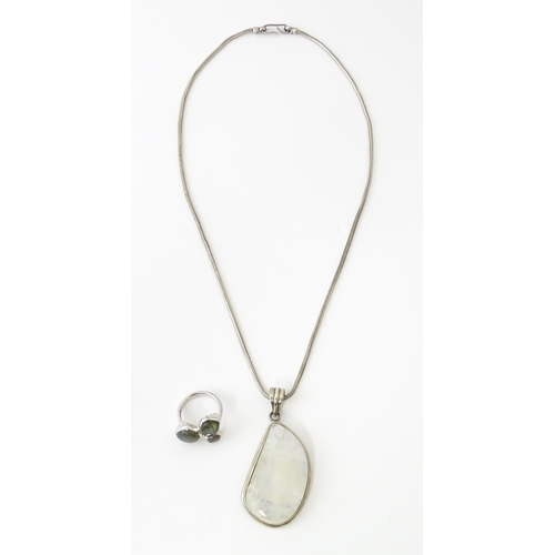 687 - A silver pendant set with labradorite hardstone. Together with a silver hardstone set with three lab... 