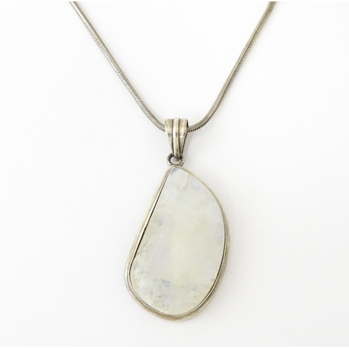 687 - A silver pendant set with labradorite hardstone. Together with a silver hardstone set with three lab... 