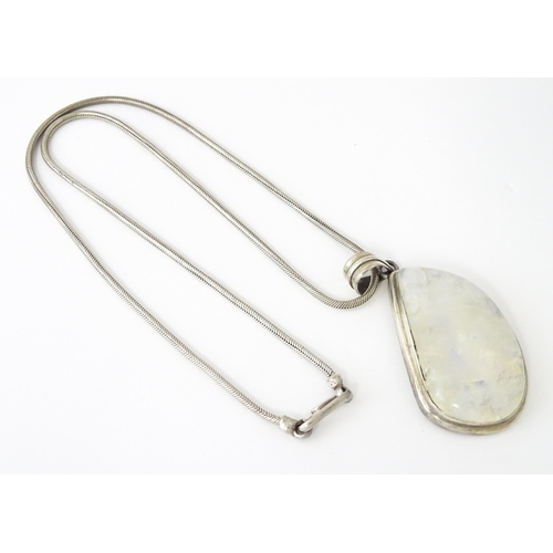 687 - A silver pendant set with labradorite hardstone. Together with a silver hardstone set with three lab... 