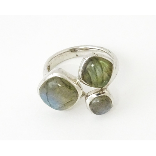 687 - A silver pendant set with labradorite hardstone. Together with a silver hardstone set with three lab... 