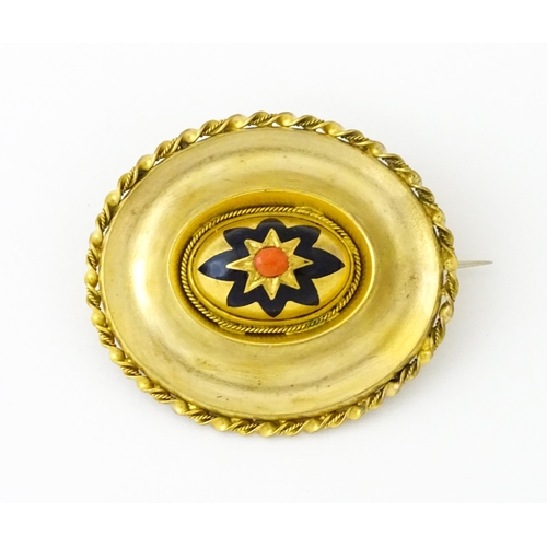 689 - A gilt enamel brooch with black enamel detail. Approx. 1 3/4