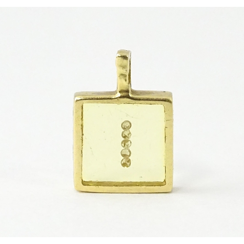 691 - An 18ct gold pendant of squared form with diamonds set to centre. Stamped Morabito. Approx. 1/2