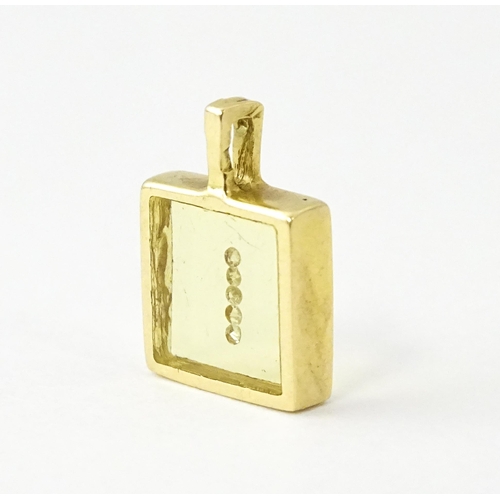 691 - An 18ct gold pendant of squared form with diamonds set to centre. Stamped Morabito. Approx. 1/2