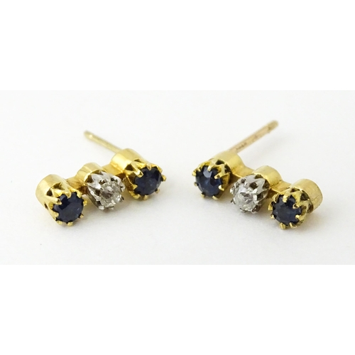 697 - A pair of 9ct gold earrings set with diamonds and blue stones. Approx. 1/2