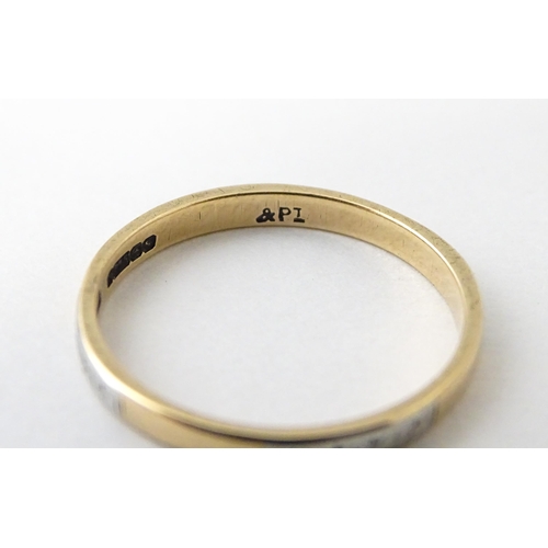 698 - A 9ct gold ring with platinum detail. Ring size approx. P