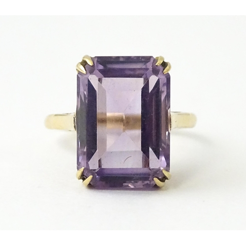 700 - A 9ct gold dress ring set with central amethyst. Ring size approx. J 1/2