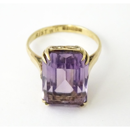 700 - A 9ct gold dress ring set with central amethyst. Ring size approx. J 1/2