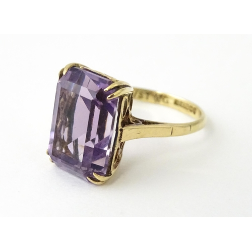 700 - A 9ct gold dress ring set with central amethyst. Ring size approx. J 1/2