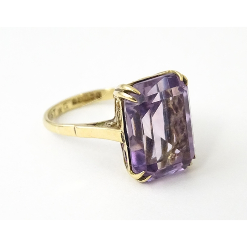 700 - A 9ct gold dress ring set with central amethyst. Ring size approx. J 1/2