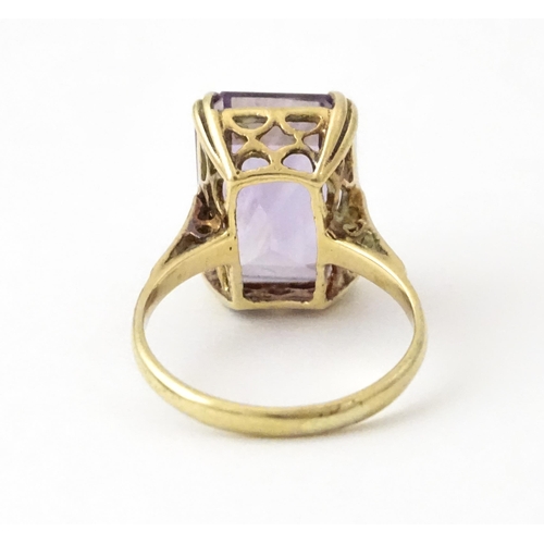 700 - A 9ct gold dress ring set with central amethyst. Ring size approx. J 1/2