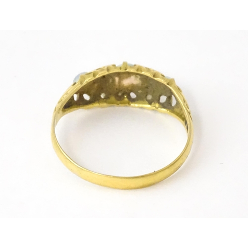 703 - An 18ct gold ring set with opals and diamonds. Hallmarked Birmingham 1915. Ring size approx. N