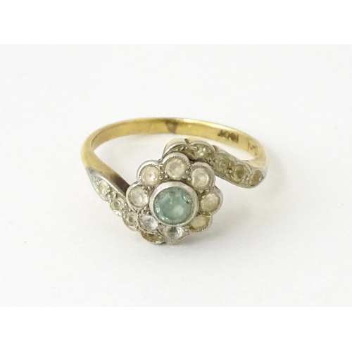 704 - An 18ct gold ring with platinum set topaz and white stones. Ring size approx. J 1/2