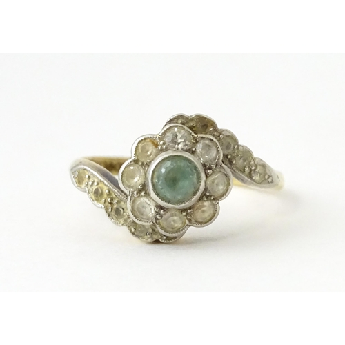 704 - An 18ct gold ring with platinum set topaz and white stones. Ring size approx. J 1/2