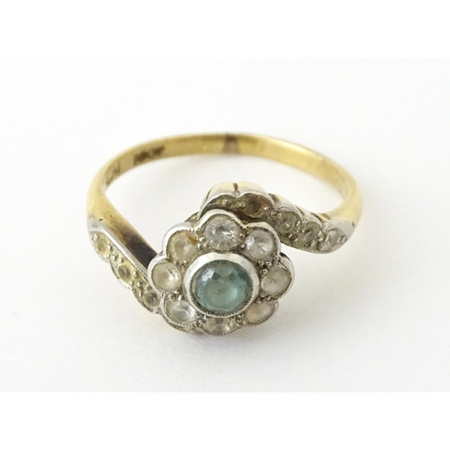 704 - An 18ct gold ring with platinum set topaz and white stones. Ring size approx. J 1/2