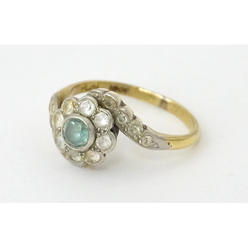 704 - An 18ct gold ring with platinum set topaz and white stones. Ring size approx. J 1/2