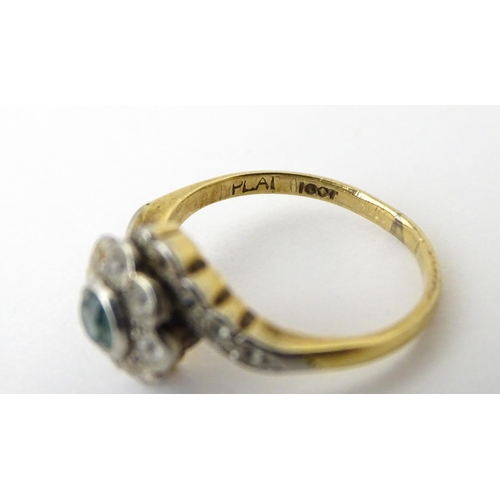 704 - An 18ct gold ring with platinum set topaz and white stones. Ring size approx. J 1/2