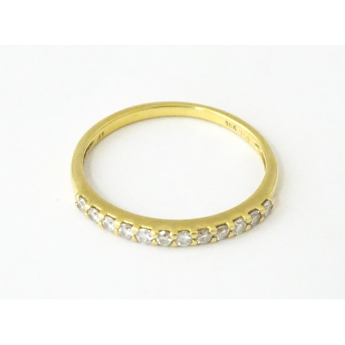 707 - An 18ct gold half eternity ring set with diamonds. Ring size approx. L