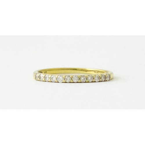 707 - An 18ct gold half eternity ring set with diamonds. Ring size approx. L