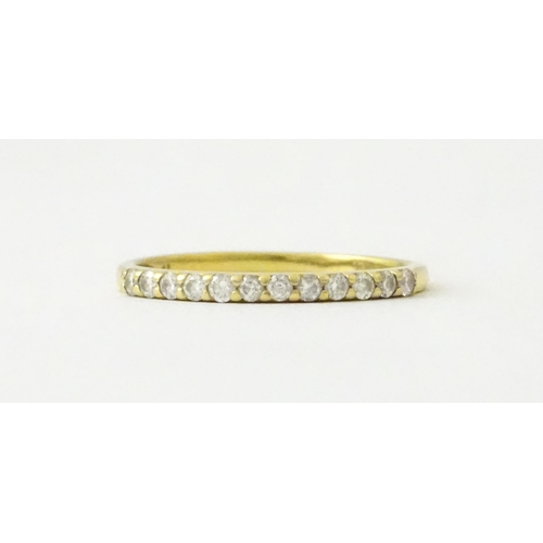 707 - An 18ct gold half eternity ring set with diamonds. Ring size approx. L