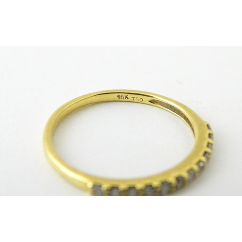 707 - An 18ct gold half eternity ring set with diamonds. Ring size approx. L