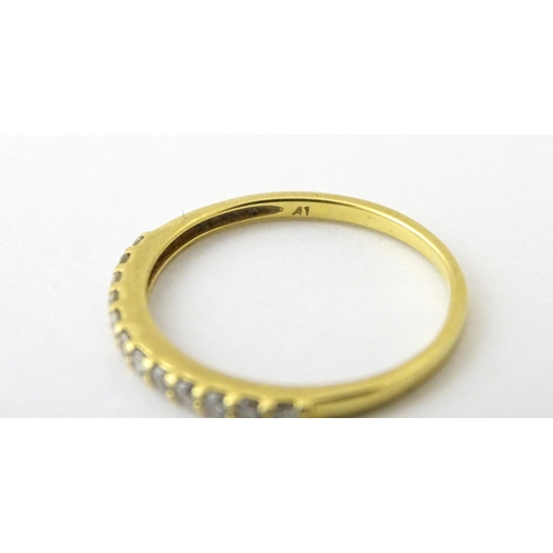 707 - An 18ct gold half eternity ring set with diamonds. Ring size approx. L