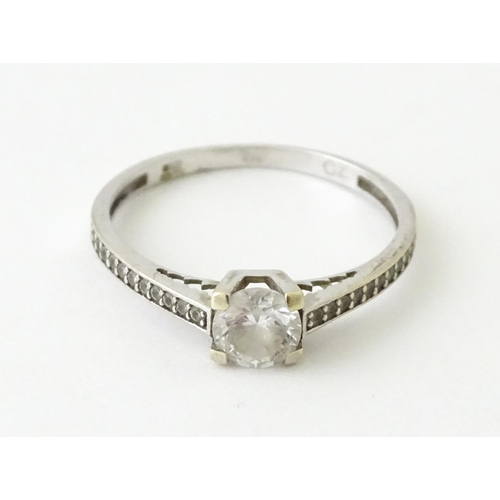 708 - A 9ct white gold ring set with cubic zirconia. Ring size approx. R 1/2