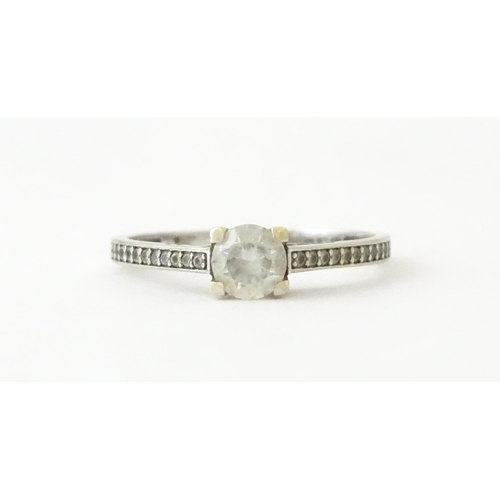 708 - A 9ct white gold ring set with cubic zirconia. Ring size approx. R 1/2