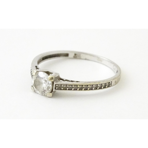 708 - A 9ct white gold ring set with cubic zirconia. Ring size approx. R 1/2