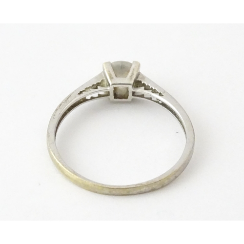 708 - A 9ct white gold ring set with cubic zirconia. Ring size approx. R 1/2