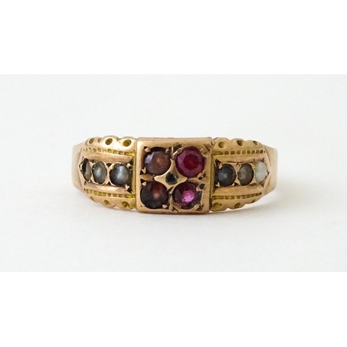 709 - A 9ct rose gold ring set with central diamond with pearls and red stones. Hallmarked Chester 1910. R... 