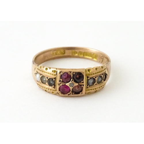 709 - A 9ct rose gold ring set with central diamond with pearls and red stones. Hallmarked Chester 1910. R... 