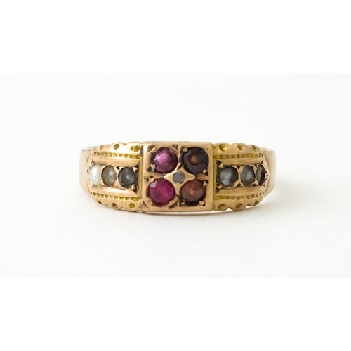 709 - A 9ct rose gold ring set with central diamond with pearls and red stones. Hallmarked Chester 1910. R... 