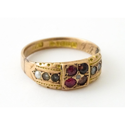 709 - A 9ct rose gold ring set with central diamond with pearls and red stones. Hallmarked Chester 1910. R... 