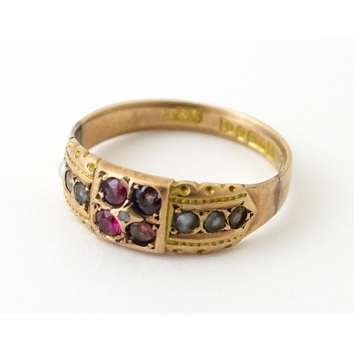 709 - A 9ct rose gold ring set with central diamond with pearls and red stones. Hallmarked Chester 1910. R... 