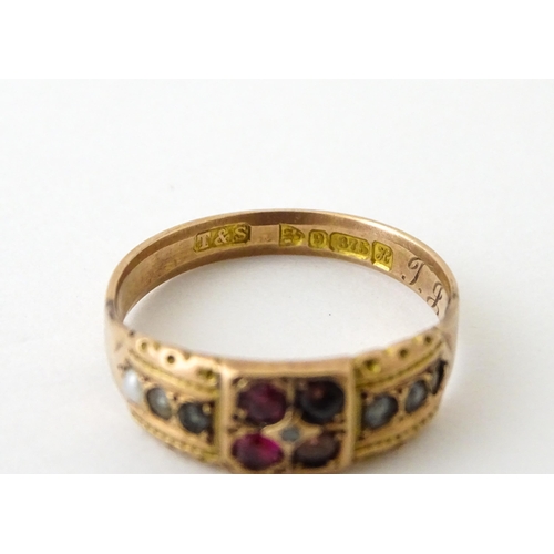 709 - A 9ct rose gold ring set with central diamond with pearls and red stones. Hallmarked Chester 1910. R... 