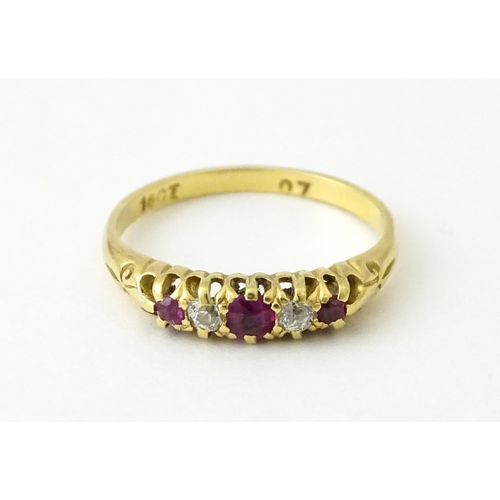 711 - An 18ct gold ring set with rubies and diamonds. Ring size approx. N