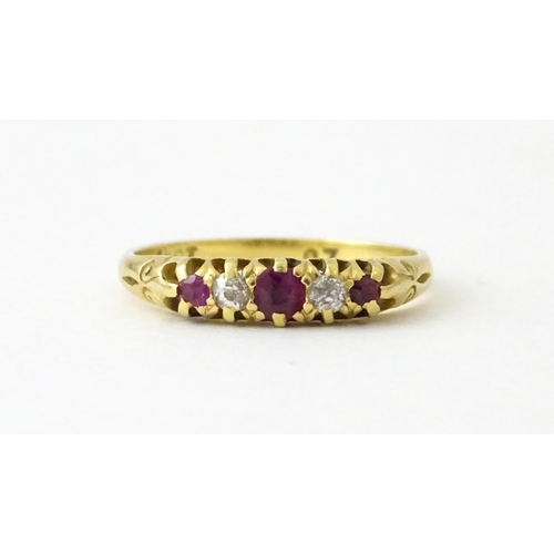 711 - An 18ct gold ring set with rubies and diamonds. Ring size approx. N