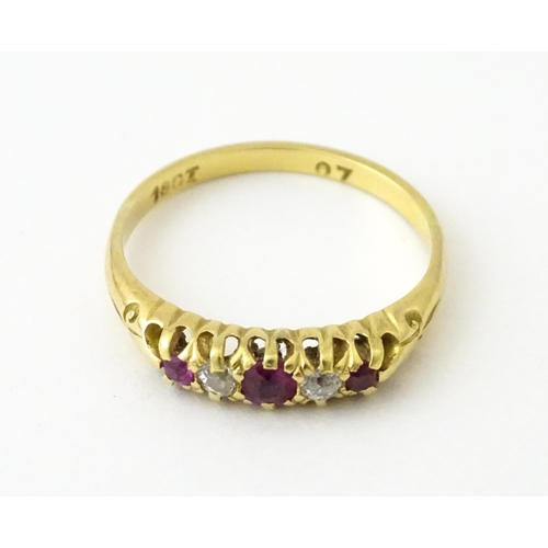 711 - An 18ct gold ring set with rubies and diamonds. Ring size approx. N