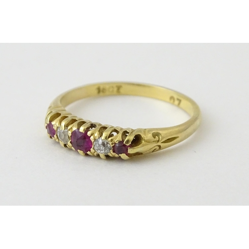 711 - An 18ct gold ring set with rubies and diamonds. Ring size approx. N