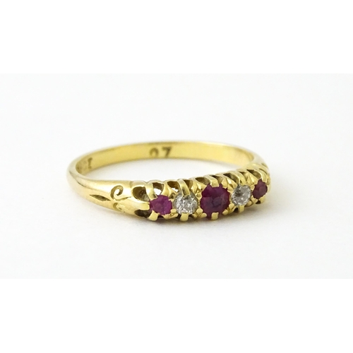 711 - An 18ct gold ring set with rubies and diamonds. Ring size approx. N