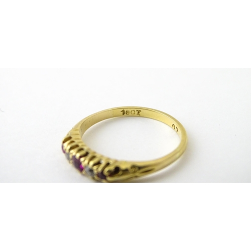 711 - An 18ct gold ring set with rubies and diamonds. Ring size approx. N