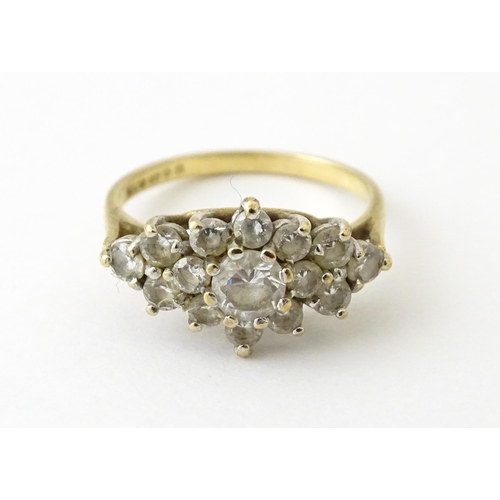 712 - A 9ct gold ring set with cluster of white stones. Ring size approx. J 1/2