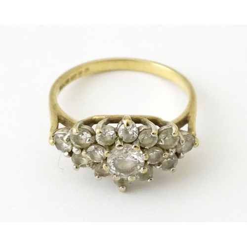 712 - A 9ct gold ring set with cluster of white stones. Ring size approx. J 1/2