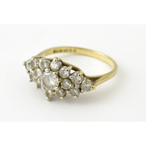 712 - A 9ct gold ring set with cluster of white stones. Ring size approx. J 1/2