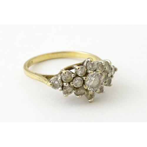 712 - A 9ct gold ring set with cluster of white stones. Ring size approx. J 1/2