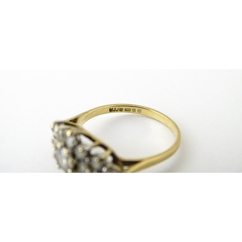 712 - A 9ct gold ring set with cluster of white stones. Ring size approx. J 1/2